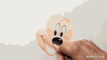 a person is drawing a cartoon character 's face with a pencil .