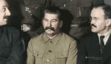 a man with a mustache is sitting next to two other men with a smithsonian channel logo