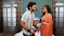 a man and woman are dancing in a bedroom