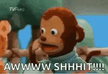 a stuffed monkey is talking on a cell phone and says awww shhhit !!!