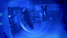 a man is standing in a blue room with a bubble around him