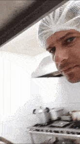 a man wearing a white plastic headband looks at the camera