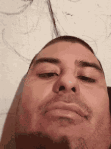 a close up of a man 's face with a white background