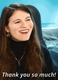 a woman is smiling with the words thank you so much behind her