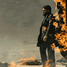 a man standing in front of a fire with the word sanjo written on the bottom