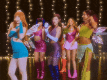 a group of girls dressed in fairy costumes are dancing