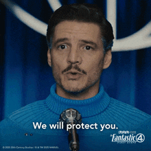 a man wearing a blue sweater stands in front of a microphone and says we will protect you