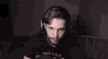 a man with a beard is wearing headphones and a microphone .