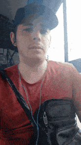 a man wearing a hat and a red shirt that says canada