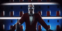 a man in a tuxedo and bow tie is holding a bottle of jack daniels whiskey .