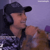 a man wearing headphones and a hat that says ' i mantadogifs ' on it