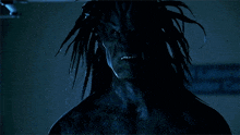 a close up of a person 's face in a dark room