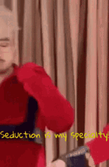 a man in a red sweater is dancing with the words seduction is my specialty written below him