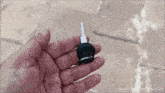 a hand is holding a small black key with youtube.com/namastecar written below it