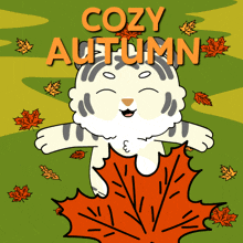 a cartoon of a cat holding a maple leaf and the words cozy autumn