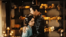 a man and a woman are hugging and kissing in a room .