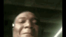 a close up of a man 's face wearing headphones .