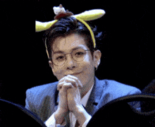 a man wearing glasses and a headband with a hello kitty on top