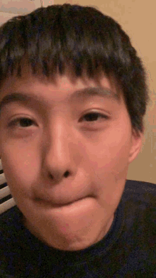 a young boy making a face with his mouth open