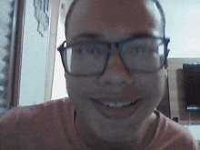 a man wearing glasses is smiling for the camera
