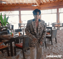 a man wearing a tiger print jacket is standing in a restaurant
