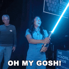 a woman holding a light saber with the words oh my gosh written below her