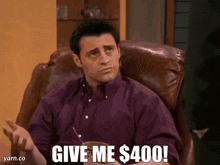 a man sitting in a chair with the words give me $ 400