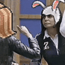 a woman in a bunny costume is giving a high five to another woman in a bunny costume .