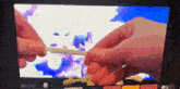 a close up of a person 's hands holding a stick