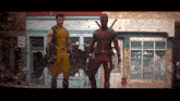 wolverine and deadpool are standing next to each other in front of a building