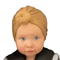 a baby with blue eyes wearing a turban