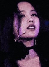 a close up of a woman wearing a choker