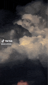 a tiktok video of a cloudy sky with a lightning bolt in the background .