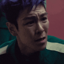 a close up of a man 's face with a slight smirk on his face