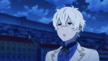 a boy with white hair is standing in front of a wall