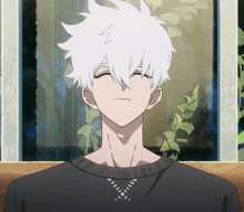 a man with white hair is wearing a black shirt with a z on it