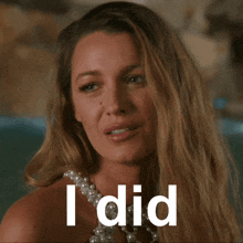 a woman wearing a pearl necklace says " i did " in white letters