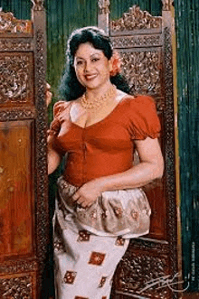 a woman in a red top and a white skirt is standing next to a wooden screen .
