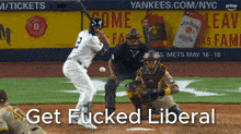 a baseball player swings at a ball in front of a jim beam ad