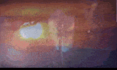a blurred image of a person 's butt with a few drops of water coming out of it