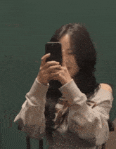 a woman is taking a picture of herself with her phone