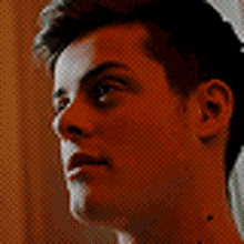 a close up of a man 's face with a tattoo on his neck