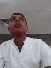 a man wearing a white shirt that says ' a. ' on it