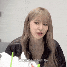 a young woman with blonde hair and the name yunjin on the bottom