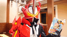 a person in a red and white costume is holding a book titled naruto