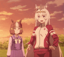 a girl in a purple skirt stands next to a girl in a red and white jacket with the letter d on it
