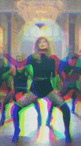 a woman in a black dress is dancing in front of a chandelier