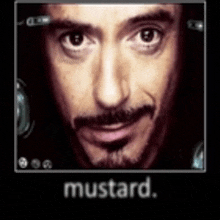 a close up of a man 's face with a mustache and the word mustard below it .