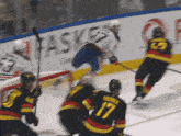 a hockey player with the number 17 on his jersey is jumping in the air