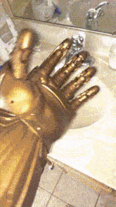 a statue of a hand is sitting on a sink